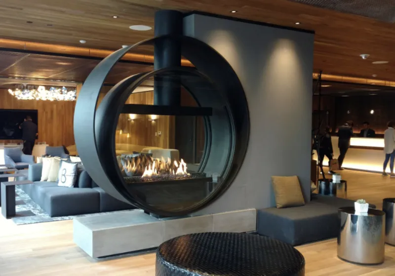 Acucraft circular custom fireplace displayed in a modern showroom setting