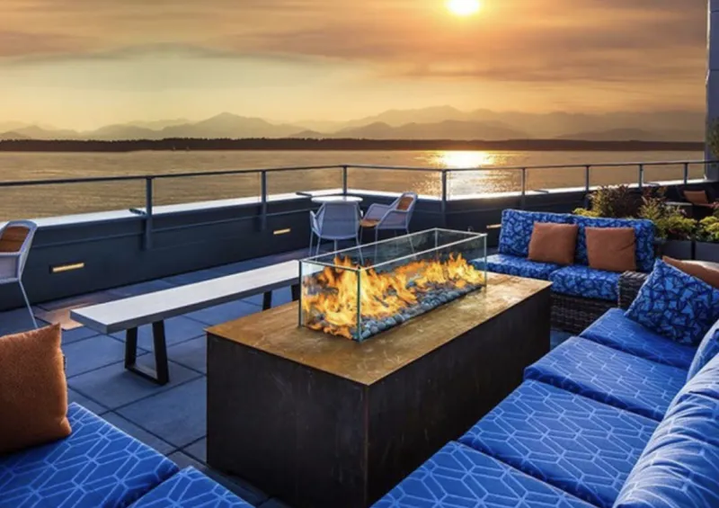 Acucraft outdoor fire table at sunset with ocean view