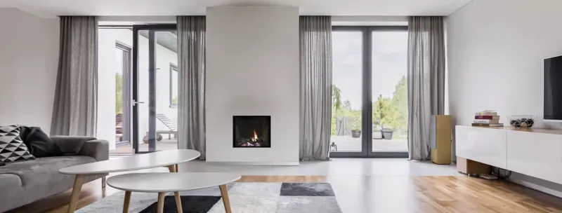 Acucraft frameless direct vent fireplace in minimalist modern living room