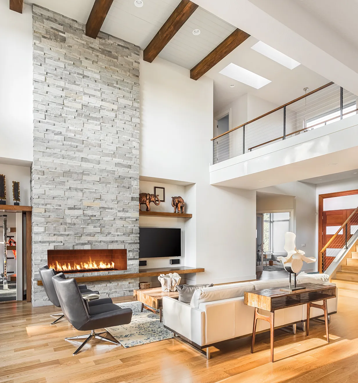 Isokern Maximus Linear fireplace in open-concept home with stone column and loft