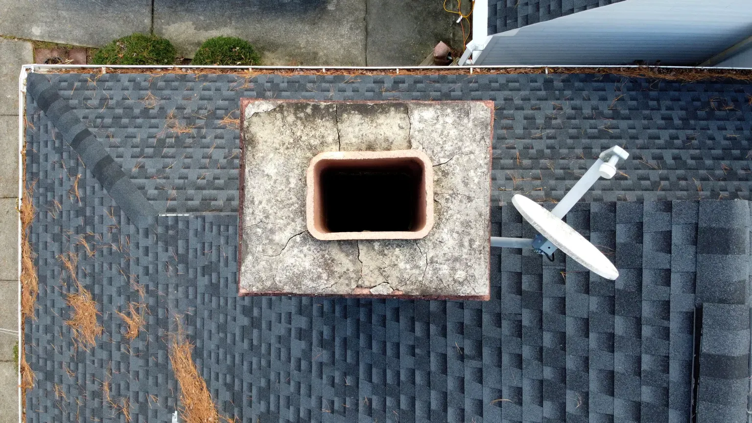 Aerial view of a cracked chimney crown in need of repair